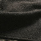 Charcoal jacket fabric close-up with dense heathered texture