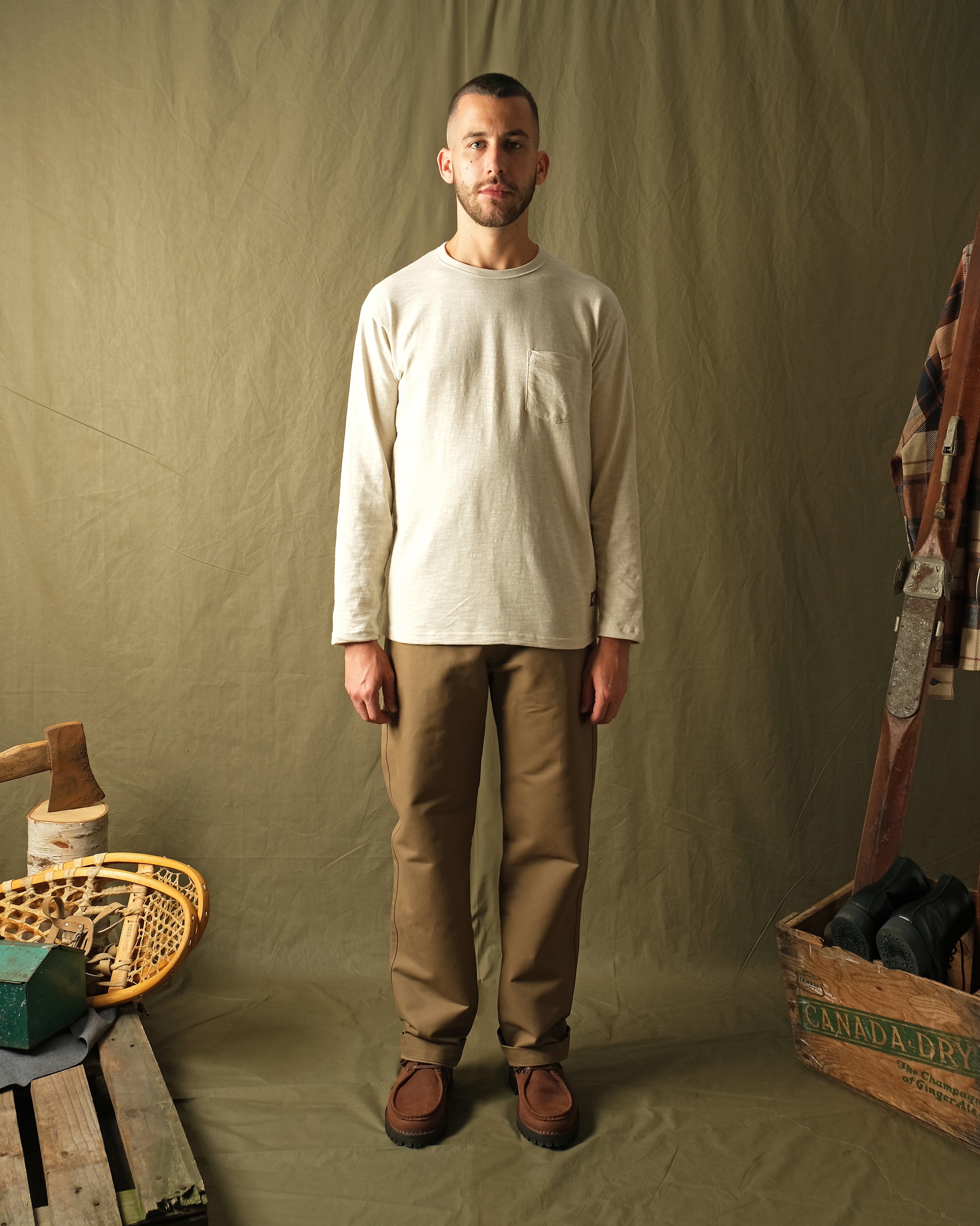 Tan moleskin engineer pants on model, straight-leg silhouette with side pockets
