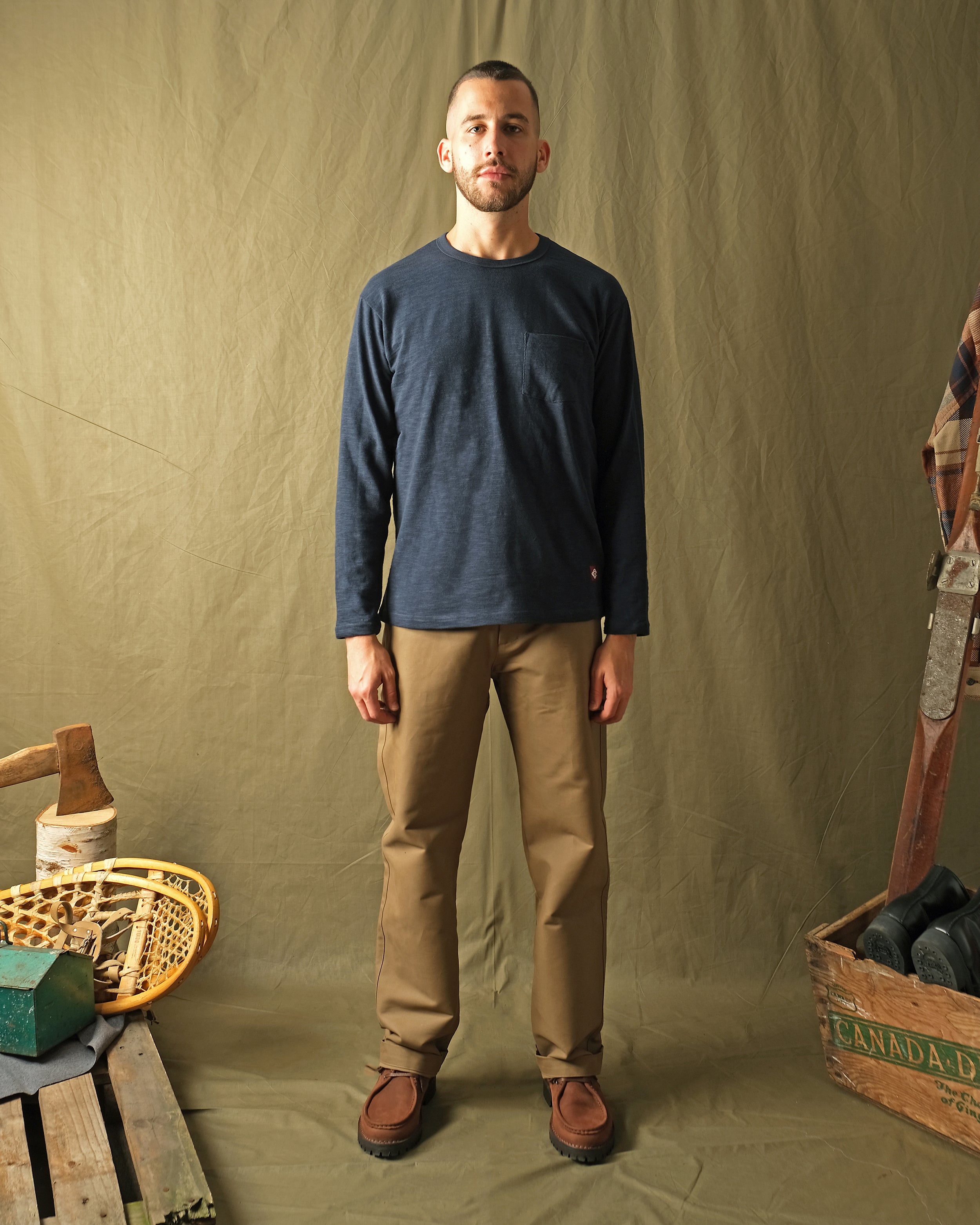 Navy long-sleeve crewneck T-shirt with chest pocket, on-model view