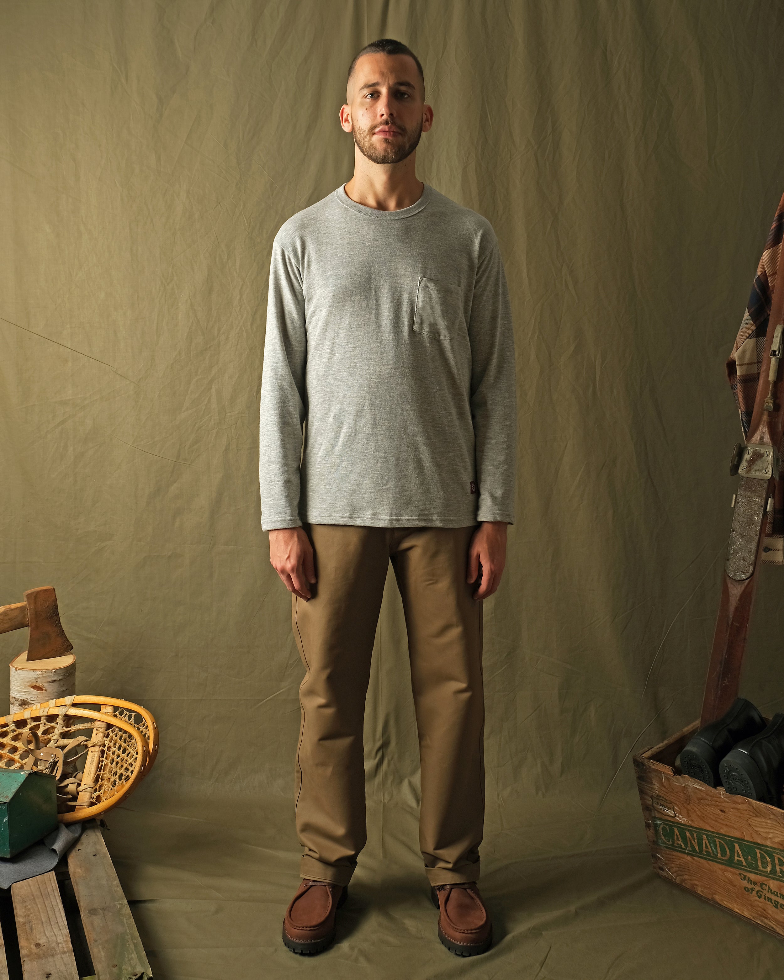 Heather gray long-sleeve t-shirt with chest pocket and crew neck worn by model