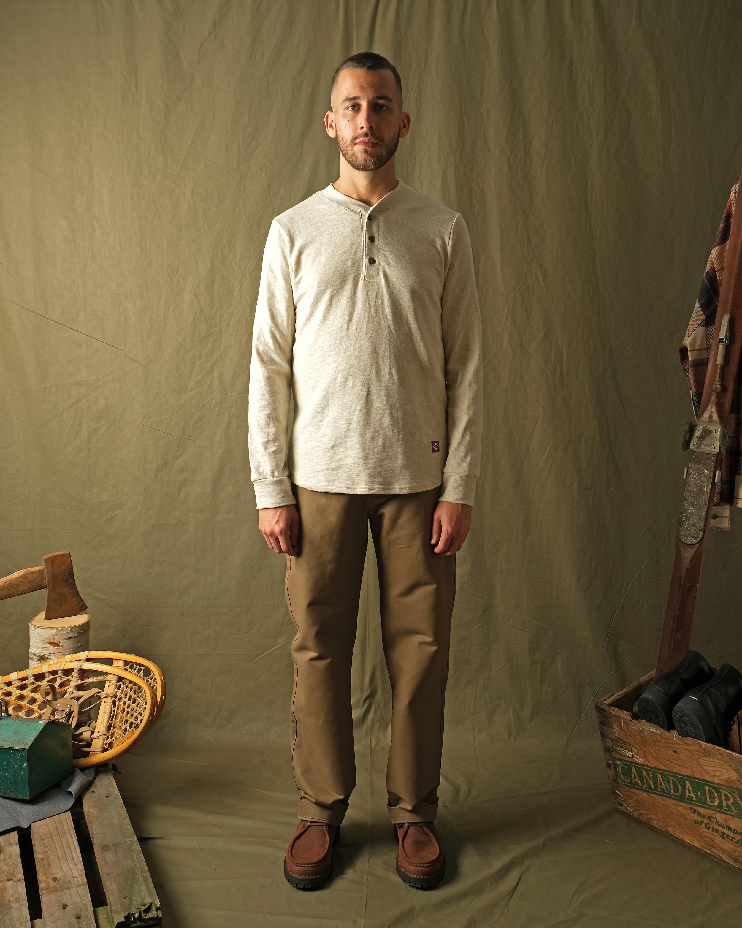 Ecru long-sleeve henley shirt on male model, buttoned front