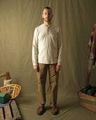 Ecru long-sleeve henley shirt on male model, buttoned front