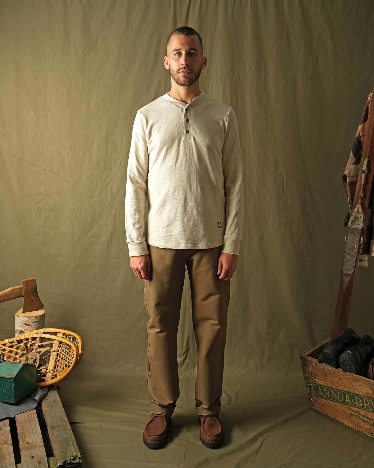Ecru long-sleeve henley shirt on male model, buttoned front