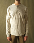 Ecru long-sleeve henley shirt on male model, three-button front