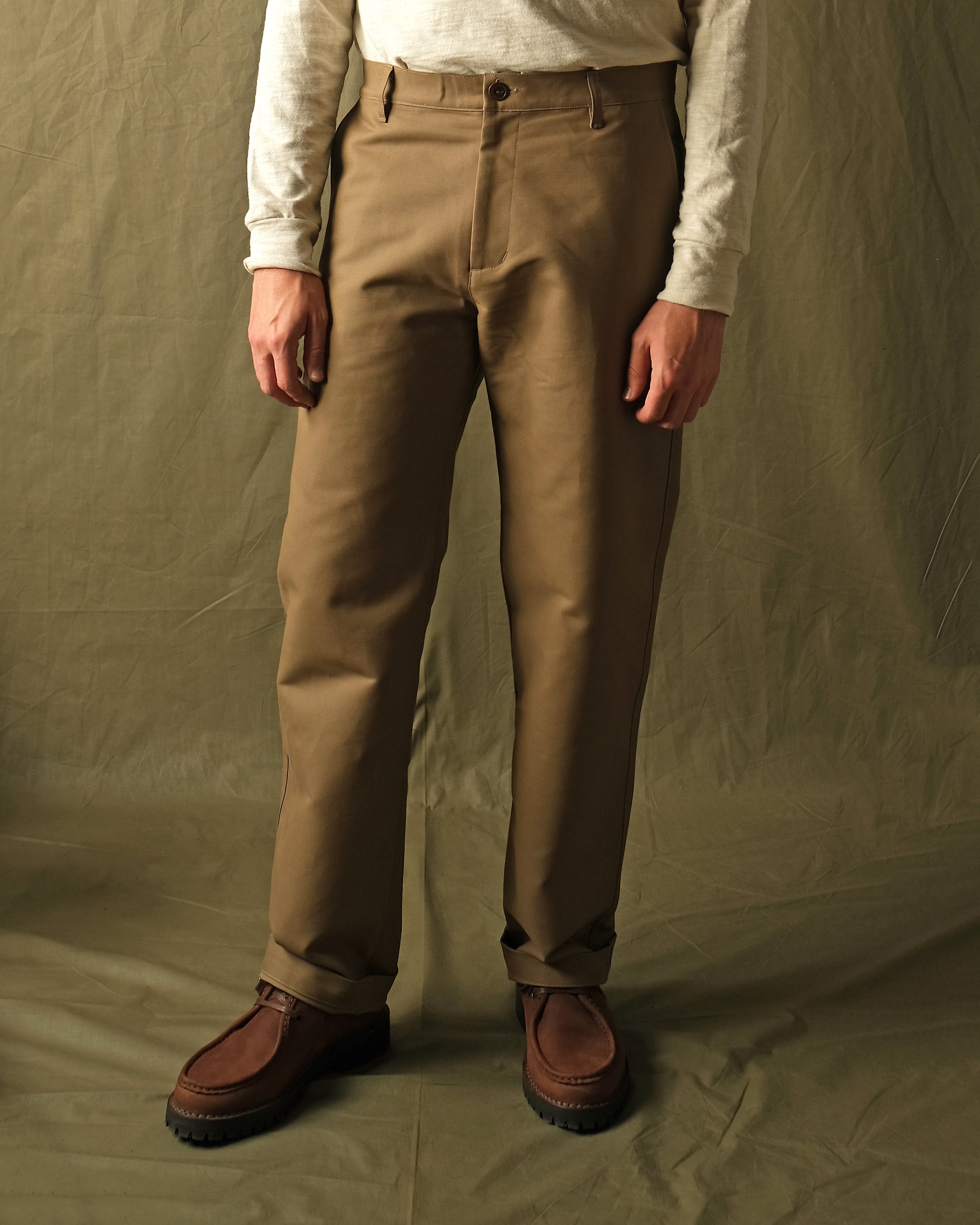 Tan moleskin engineer pants worn with straight legs and visible side seams
