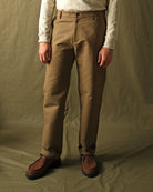 Tan moleskin engineer pants worn with straight legs and visible side seams