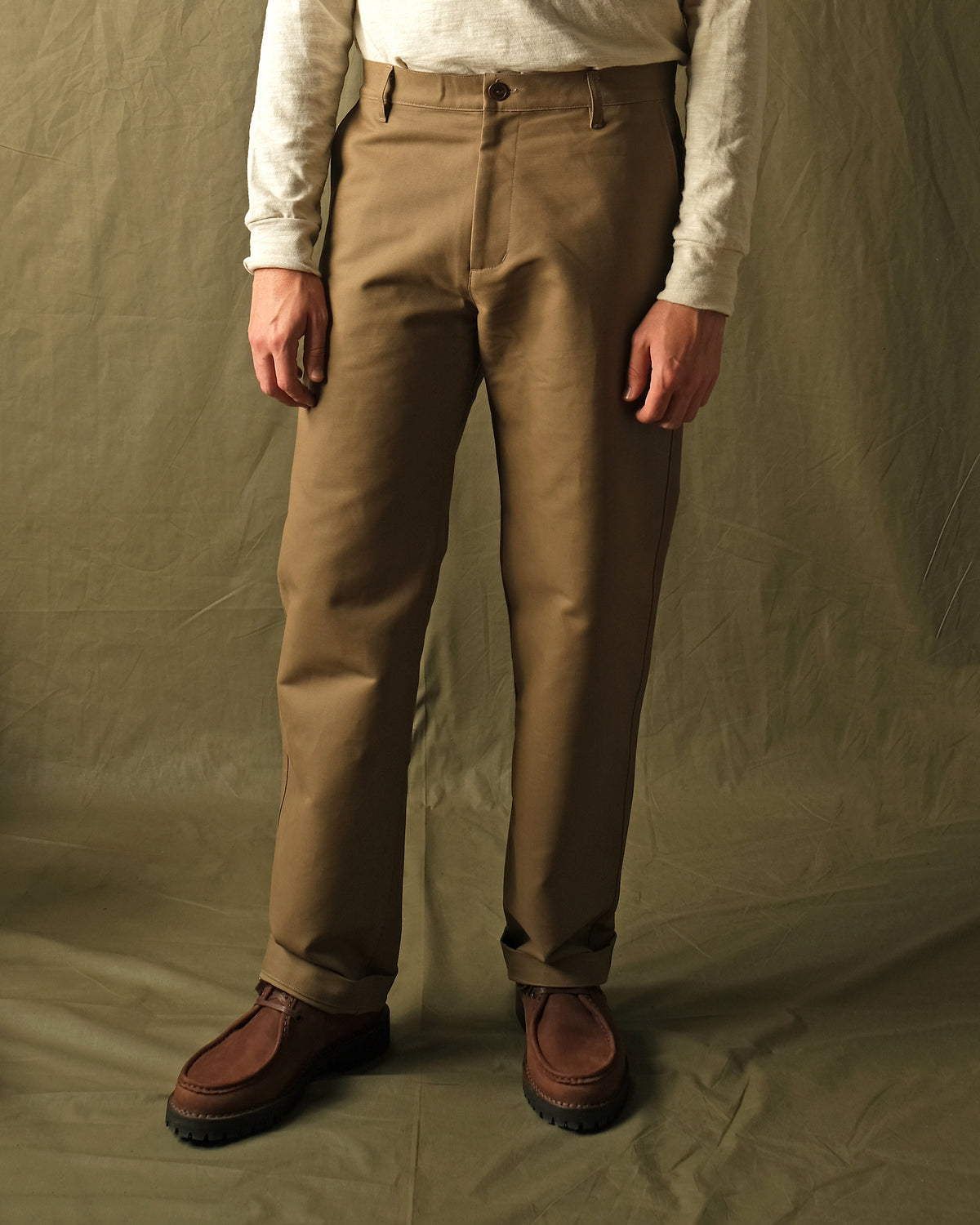 Tan moleskin engineer pants worn with straight legs and visible side seams