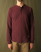 Maroon long-sleeve henley shirt on model, textured knit and button placket