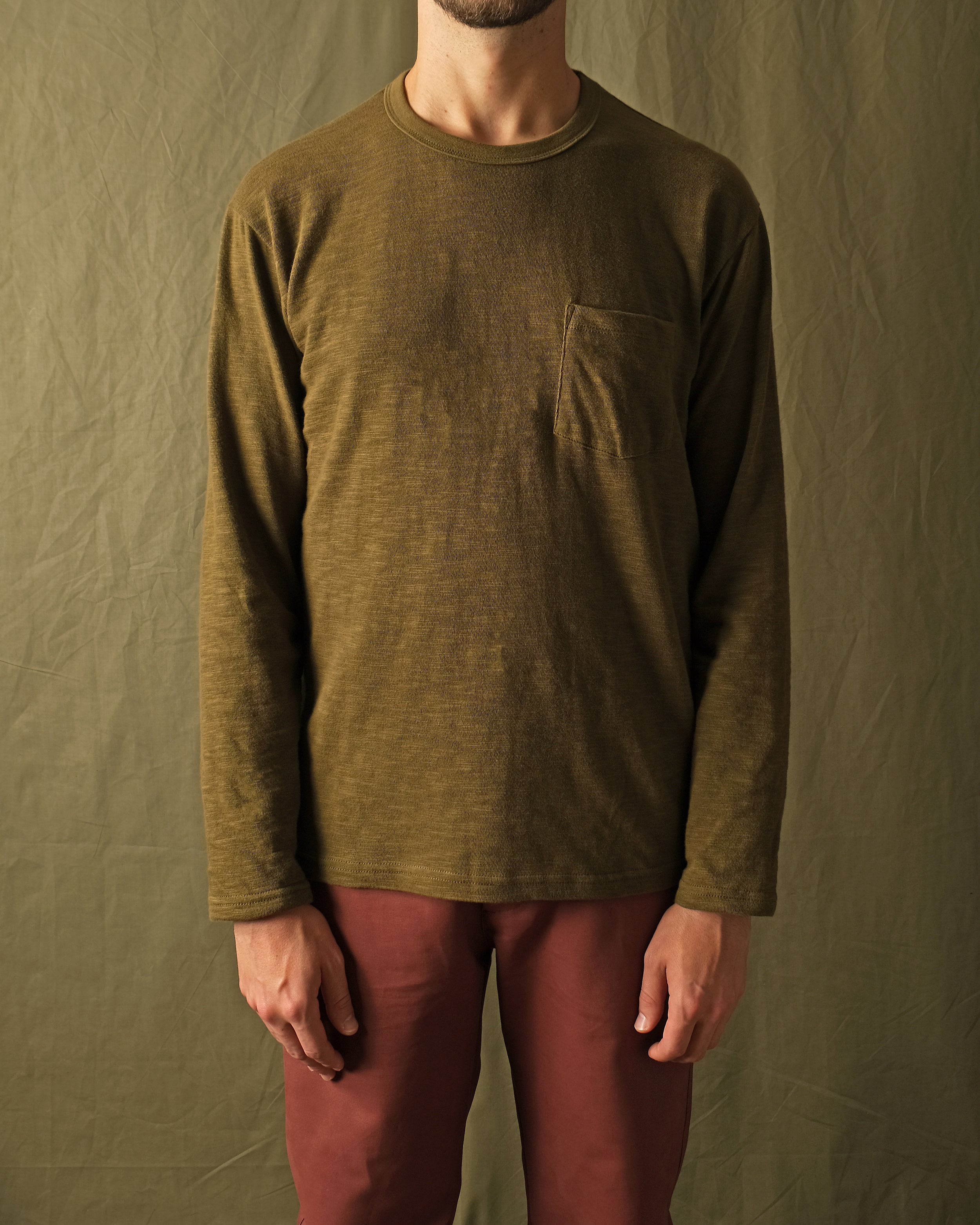 Olive long-sleeve pocket T-shirt on model, textured slub knit