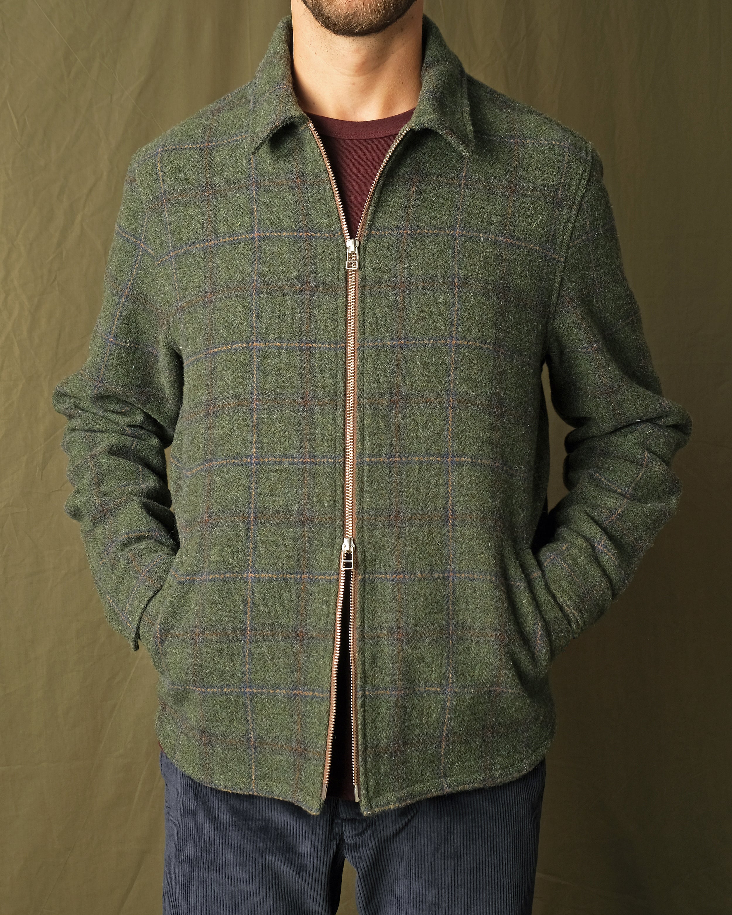 Olive green plaid wool zip overshirt, front view with stand collar and zipper