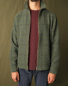 Olive green plaid wool zip overshirt on model, stand collar and visible zipper