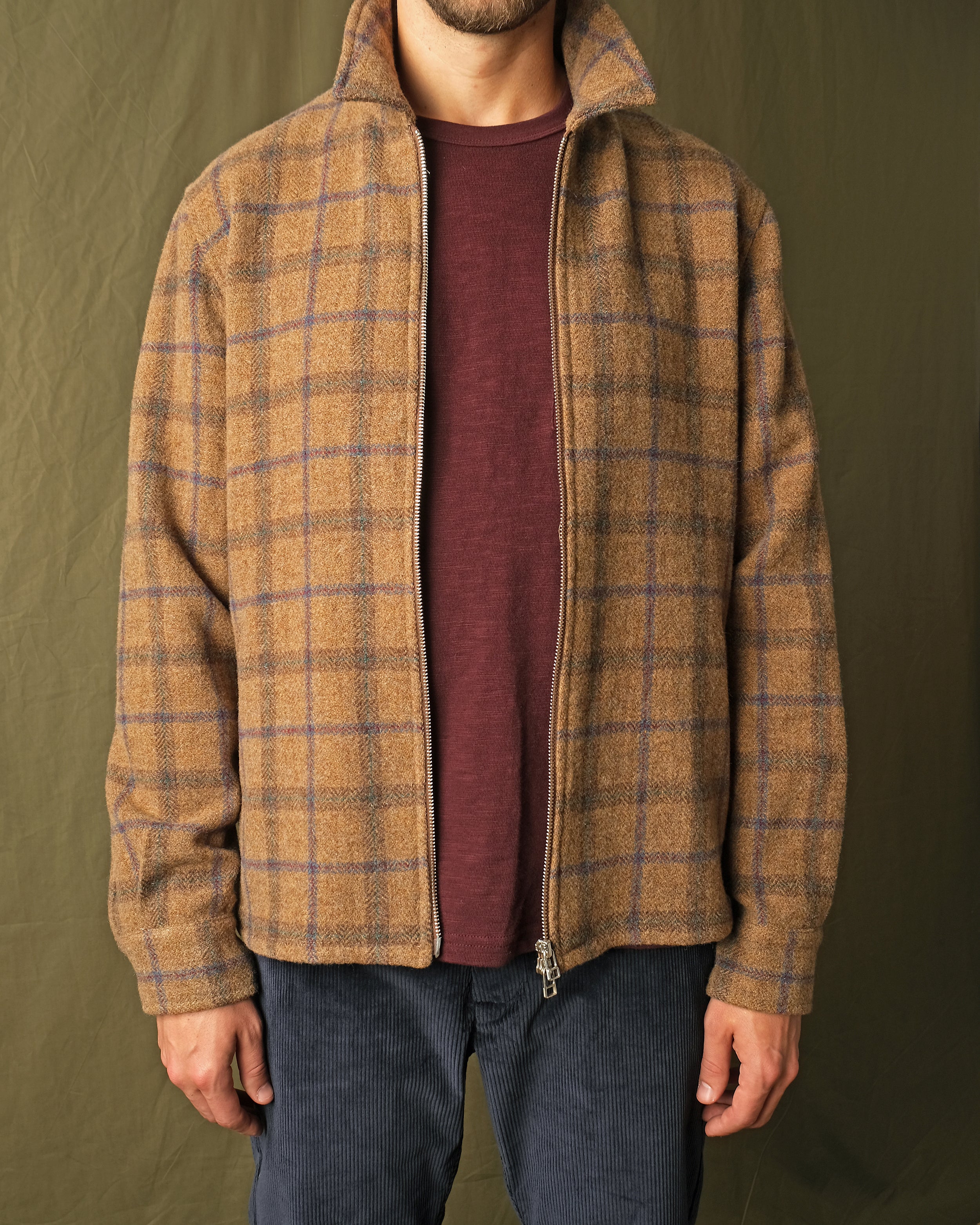Wool plaid zip overshirt worn slightly open, collared neckline, metal zipper, cuffs