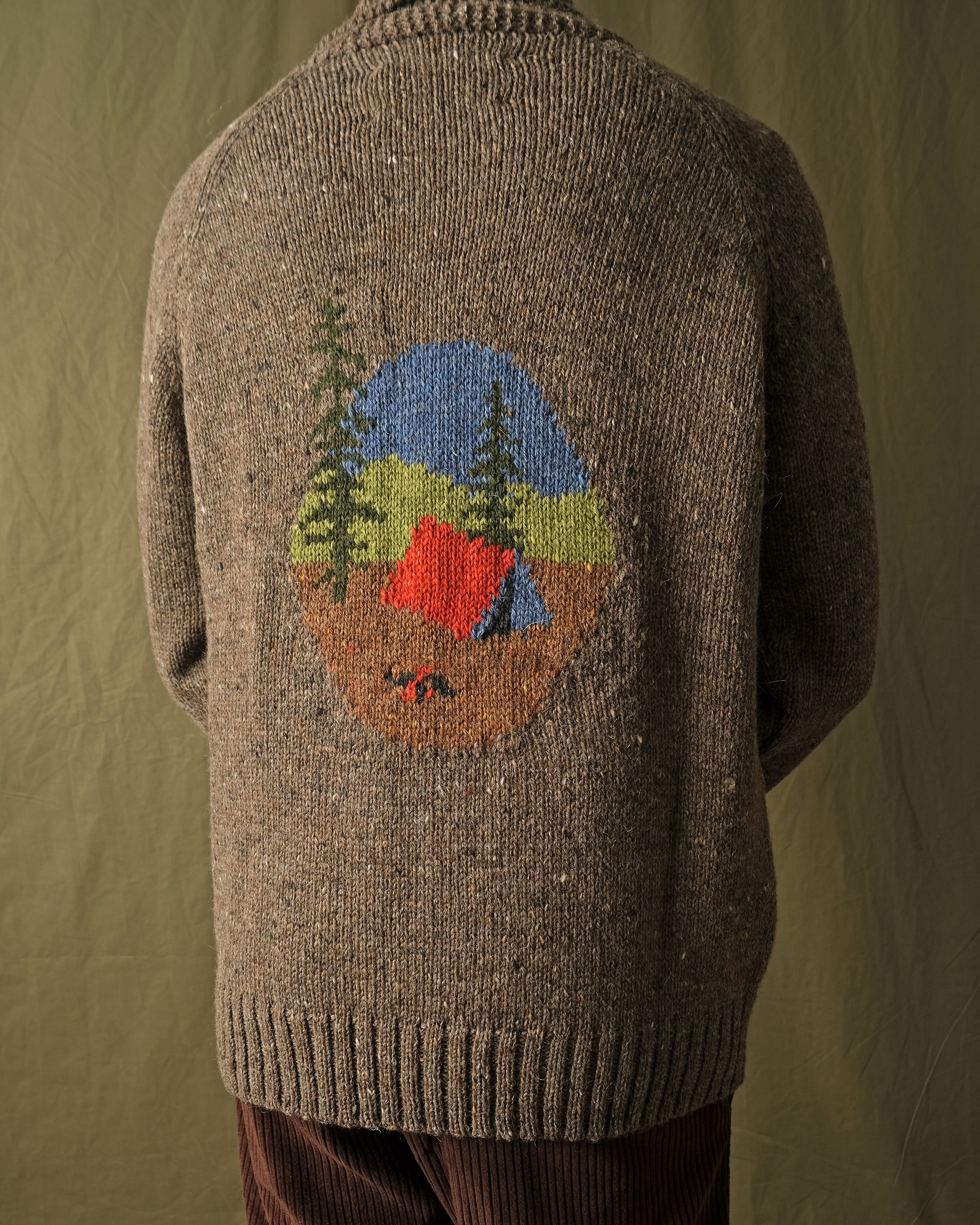 Brown full-zip cardigan worn by a man, camp scene motif centered on the back