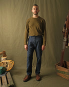 Navy herringbone pleated pants worn with casual top; straight leg fit