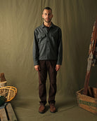 Dark charcoal speckled wool camp shirt on model, long sleeves and flap chest pockets.