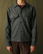 Charcoal fleck wool camp shirt with camp collar and flap chest pockets visible on model.