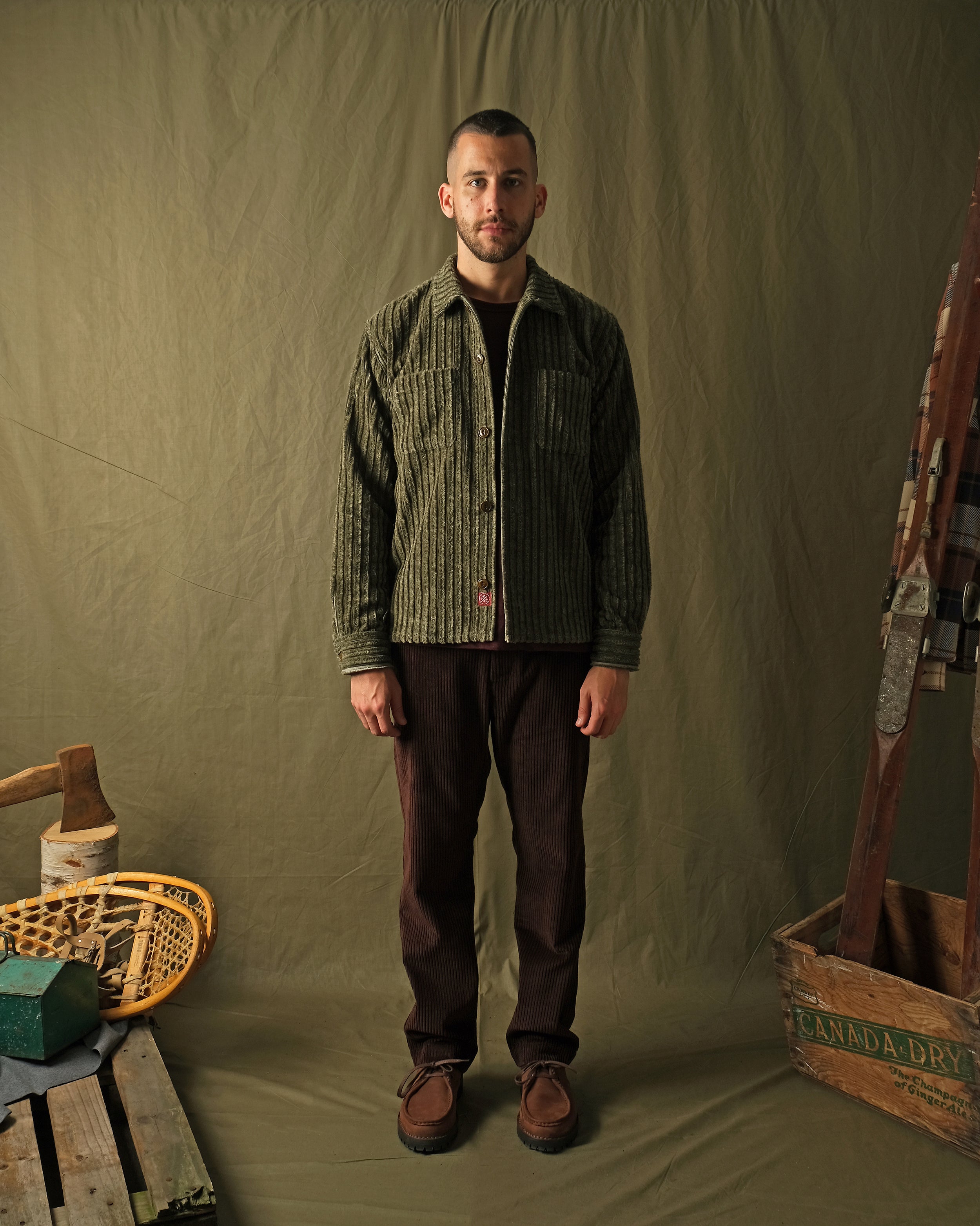 Olive jumbo corduroy club shirt on model, button-front and long sleeves