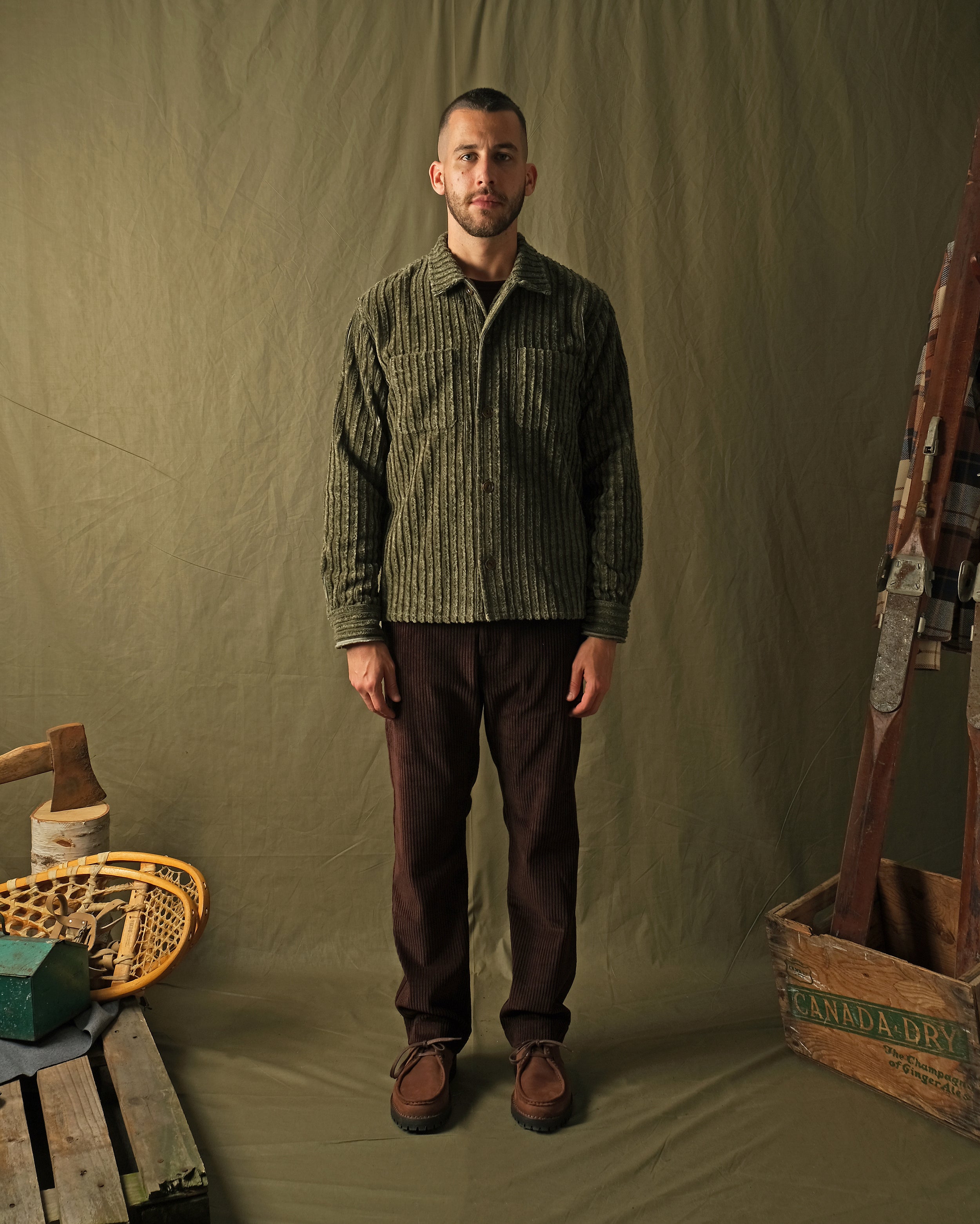 Olive jumbo corduroy club shirt on model, front view with spread collar and brown buttons