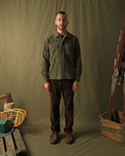 Olive jumbo corduroy club shirt on model, front view with spread collar and brown buttons