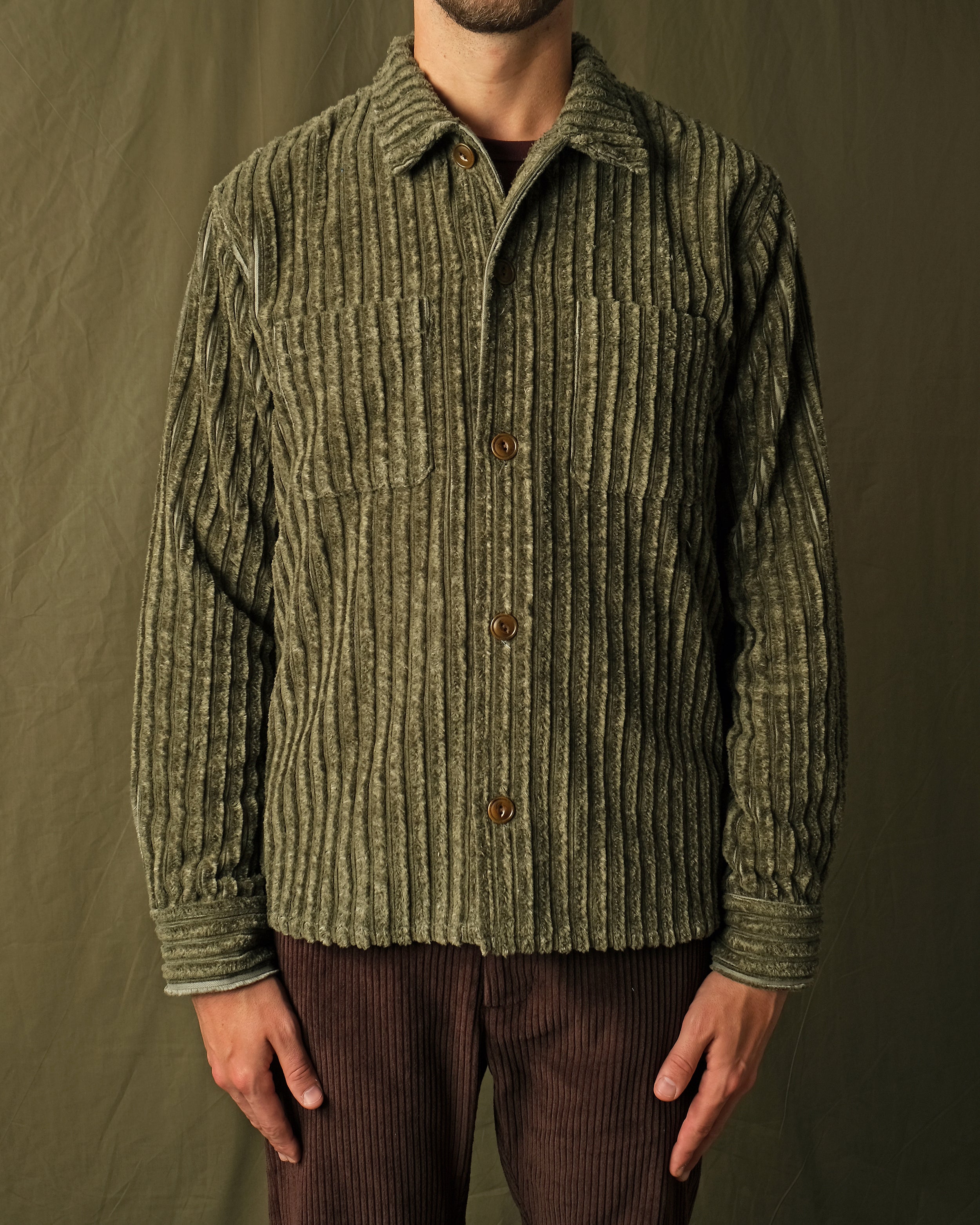 Olive jumbo corduroy club shirt on model, spread collar, brown button placket, long sleeves