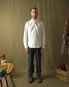 White Oxford button-up shirt on model with long sleeves and buttoned front