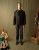 Charcoal stadium jacket worn by model, stand collar and front welt pockets