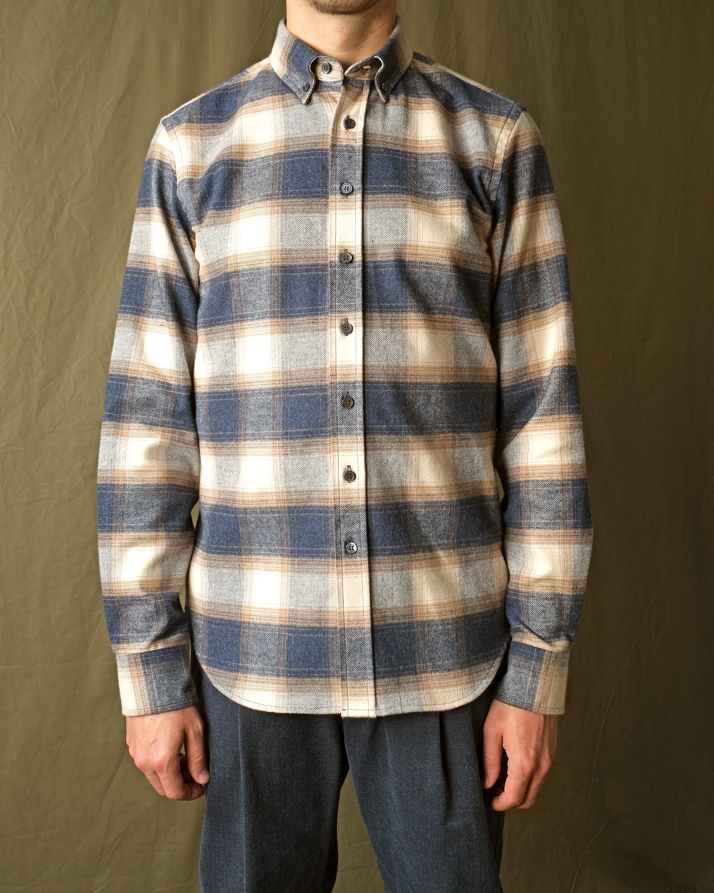 Blue and cream plaid flannel shirt with button-front long sleeves and pointed collar
