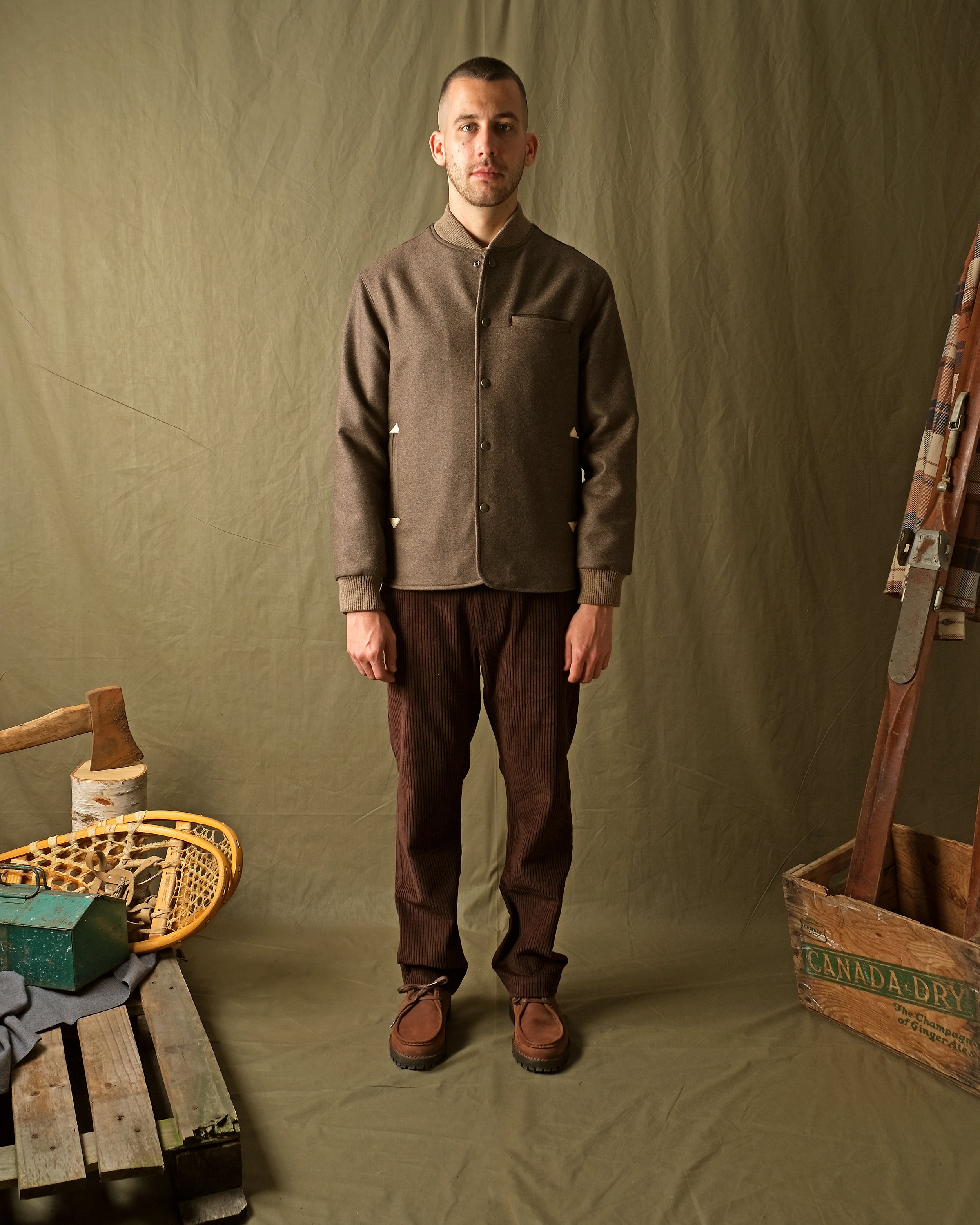 Mens brown stadium jacket with snap front, stand collar, chest pocket, ribbed cuffs