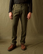 Olive washable wool pleated pants with front fly and side pockets, straight legs