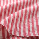Red-and-white striped shirt sleeve and side seam detail