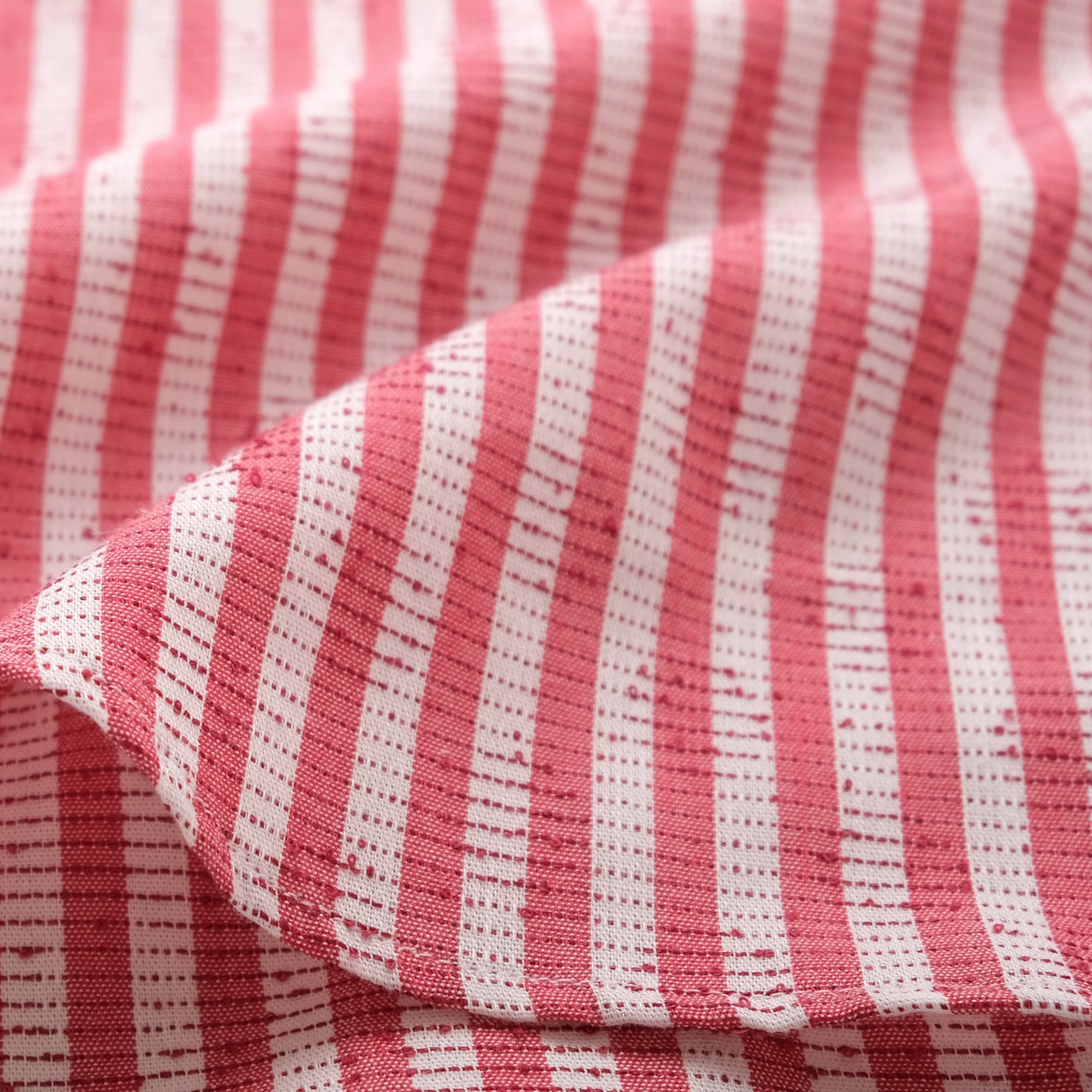 Red-and-white striped shirt sleeve and side seam detail