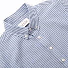 Light blue striped short-sleeve button-up shirt collar and button placket detail