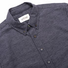 Slate blue short-sleeve button-up shirt showing neck label and front buttons