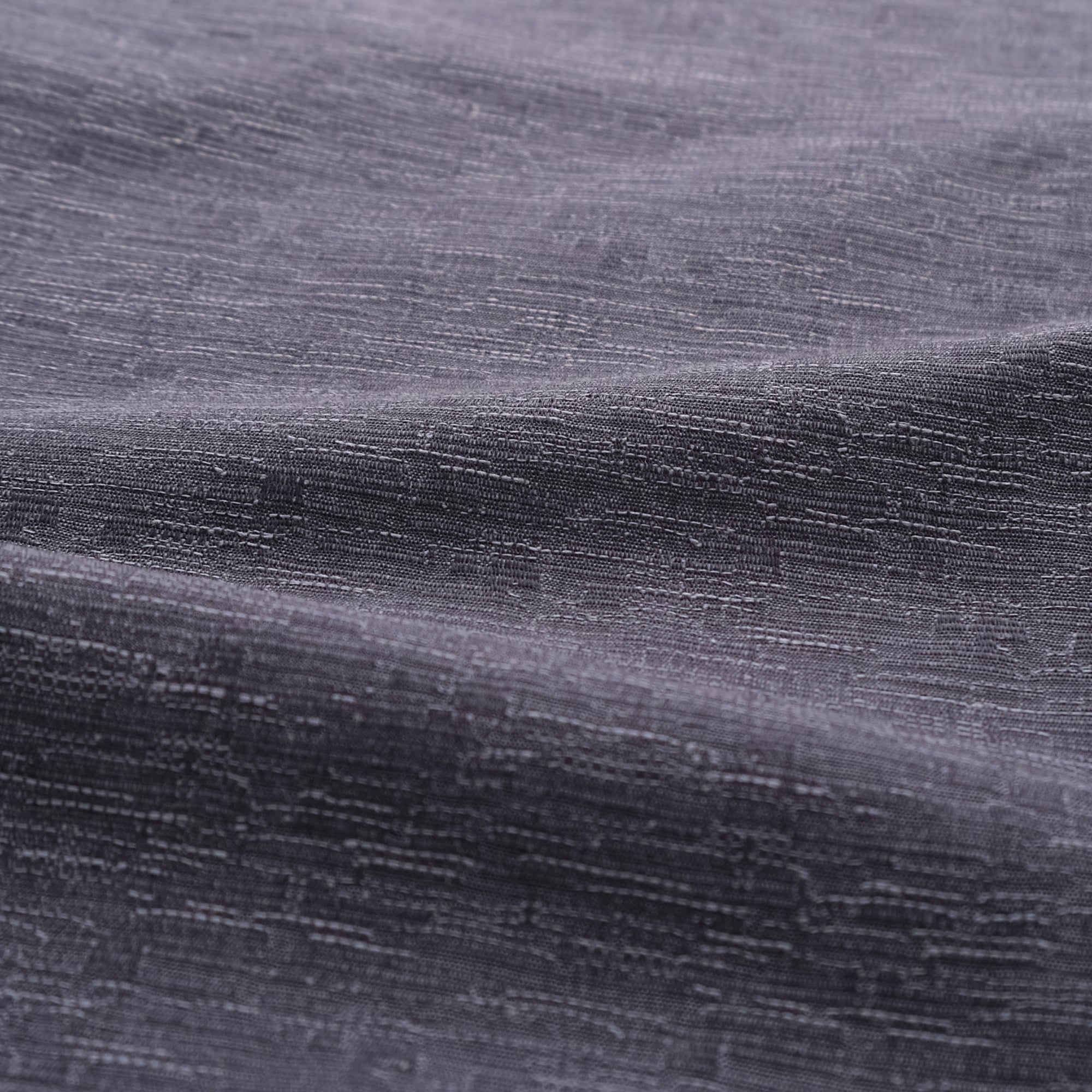 Slate blue shirt fabric close-up with fine textured weave